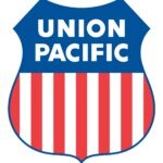 Logo of Union Pacific Railroad, featuring shield with red, white, and blue colors, along with the company name in bold font.