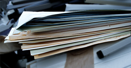 A stack of papers with another stack of papers on top, creating a pile of documents