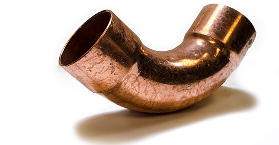 A copper pipe against a white background, showcasing its metallic shine and smooth surface.