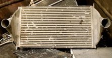 Image of a metal radiator surrounded by scrap metal.